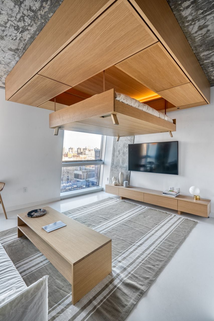 Furniture rises into the ceiling of the Smile studio apartment to free up precious floor space.