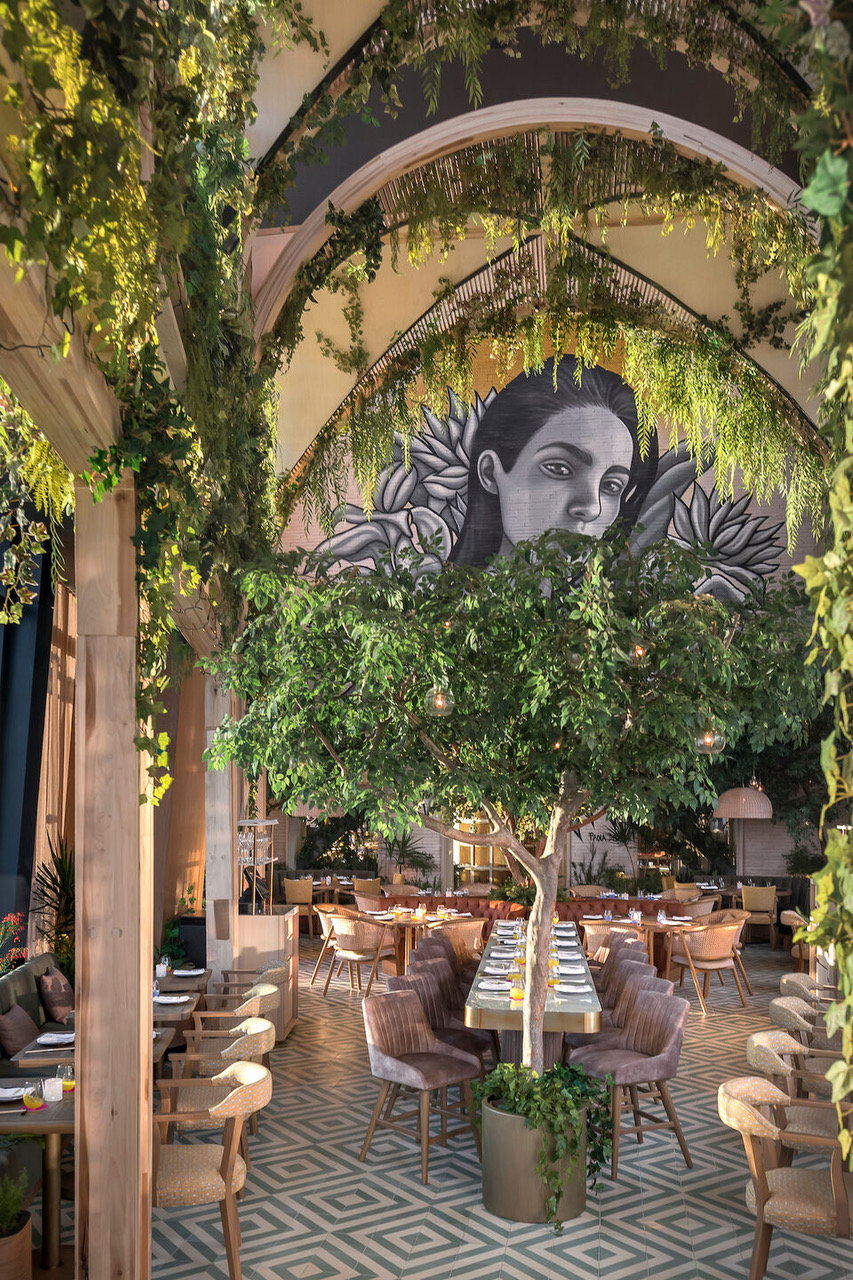 A triple-height ceiling and a beautiful background mural give the Ling Ling restaurant's atrium the feel of a traditional Mexican courtyard. 