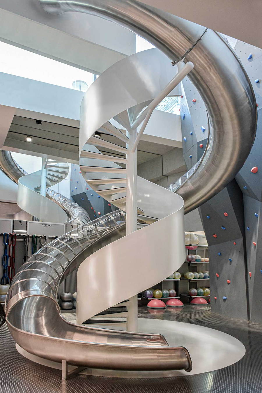 A curving metallic slide sits at the center of Beijing's new MFIT SPACE 01 gym. 