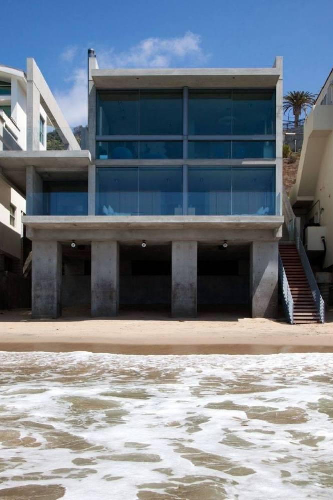 View up at Kanye West's Tadao Ando-designed Malibu beach house from the beach. 