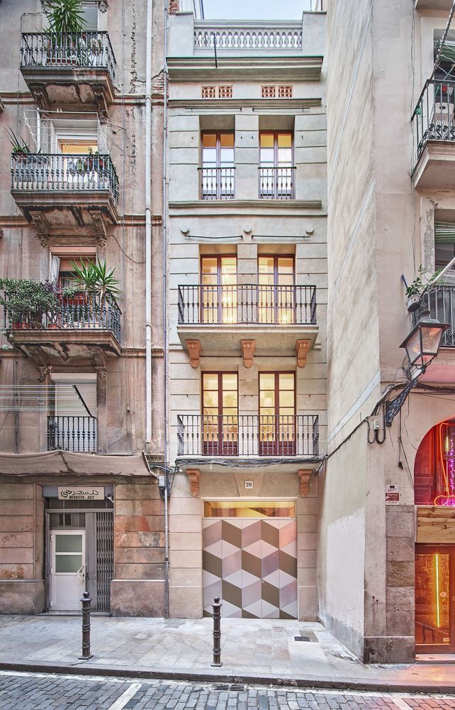 Street view of the Raúl Sánchez-remodeled BSP 20 Barcelona Apartment reveals a striking graphic front door.