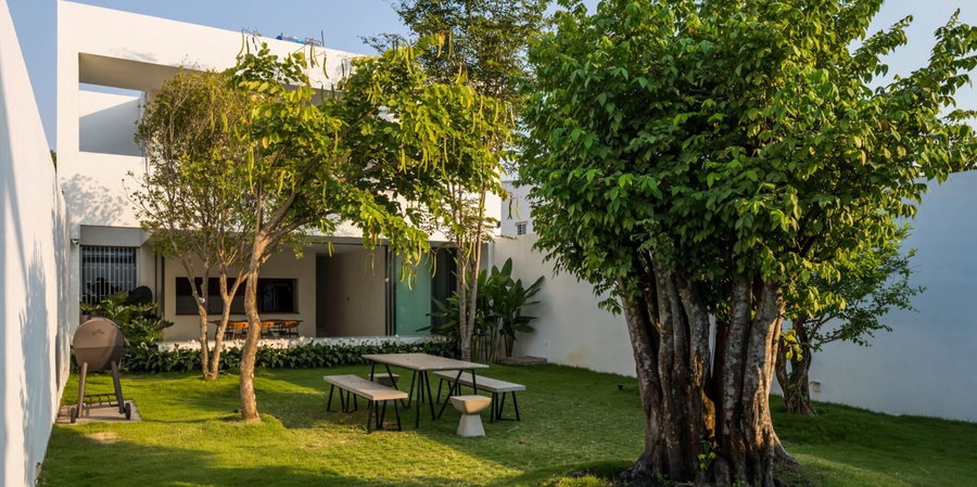 Verdant outdoor courtyard breaks up the indoor spaces of the 23o5 Studio-designed Longcave 2 home.  
