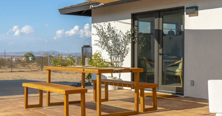 Simple wooden bench on the patio of 636 Valencia Drive offers breathtaking views of the surrounding Mojave Desert.