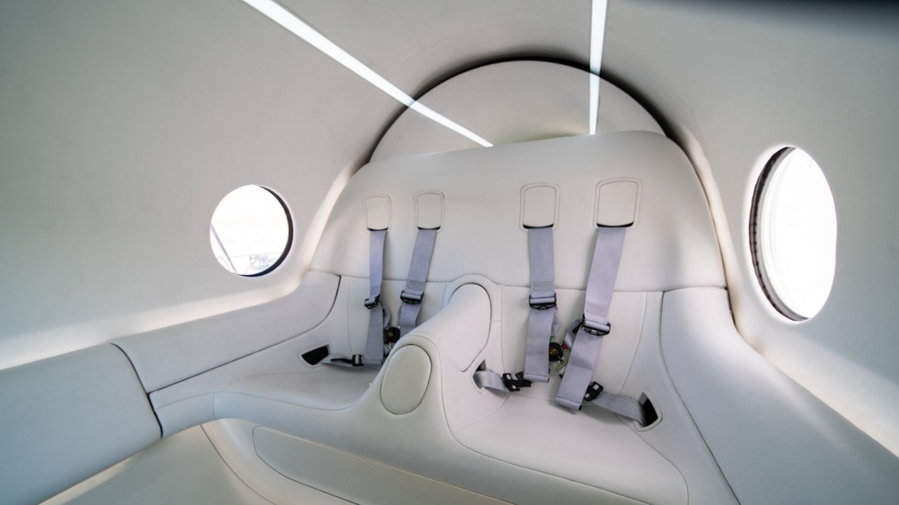 Inside the Virgin Hyperloop pods, big white seats and wide harnesses sit waiting to whisk passengers away.