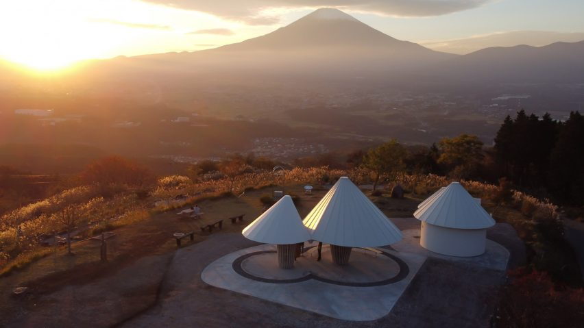 View of Kuma's conical mountain-like public toilets as the sun sets over Oath Hill Park. 