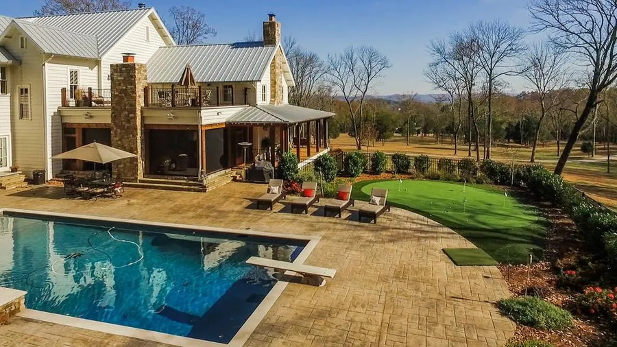 In-ground pool and small putting green in the back of Miley Cyrus' Nashville ranch.