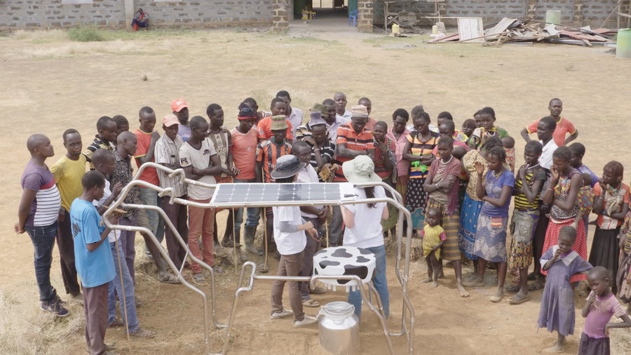 Kenyan schoolchildren gather around a communal 