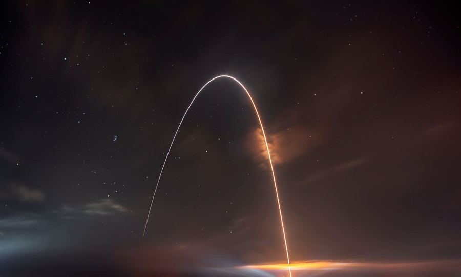The Apollo 11 pod rips through the sky as it re-enters the Earth's atmosphere