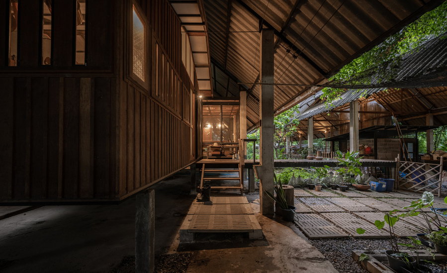 Reclaimed wooden walkways and shared outdoor spaces make up a lot of the reclaimed Kha-Nam Noi House.