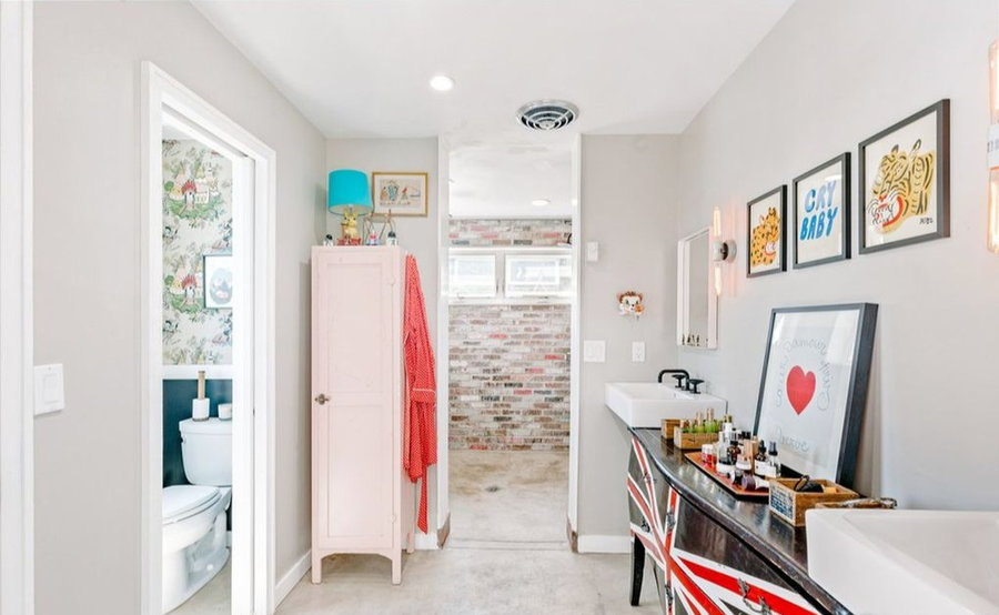 An adorable vintage bathroom inside the handcrafted shipping container home.