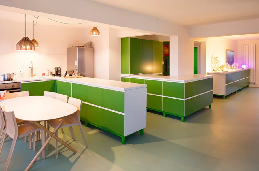 The green cabinets in Le Rainbow et le Bousquet's kitchen and dining areas make up the 