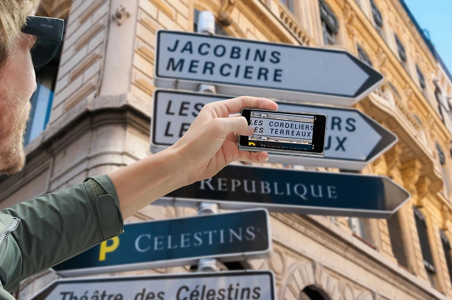 Traveler uses the Fluentalk T1's built-in camera to translate street signs in a foreign country.