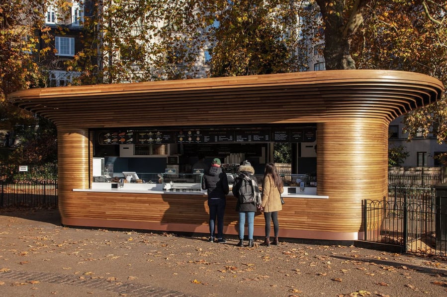 Customers line up to get drinks at Mizzi Studio's refreshment kiosks in London Royal Parks.