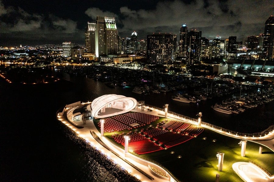 Nighttime view of the conch-like Rady Shell concert hall in San Diego's Jacobs Park.