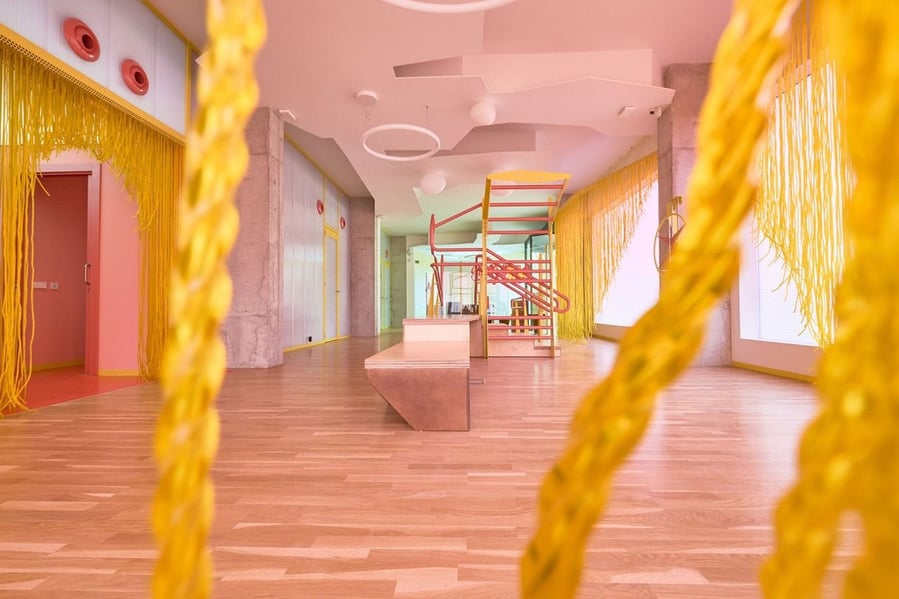 Tactile yellow fringe adorns the pink common areas inside the Form of Care traumatology clinic.