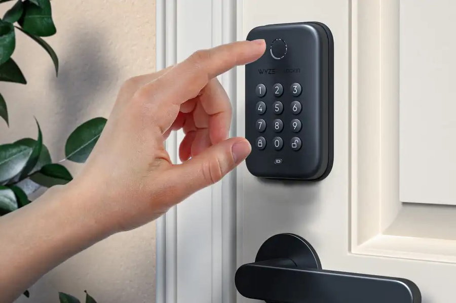 Persons scans their fingerprint with the Wyze Lock Bolt to instantly unlock the door.