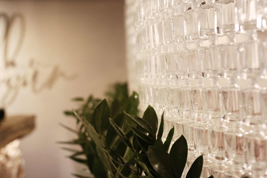 Nail polish bottles have been cut to form a dazzling glass wall inside the Angel Salon.