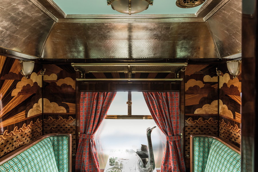 Wood marquetry featuring cinematic clouds inside Wes Anderson's restored 1950s-Era Cygnus Carriage. 