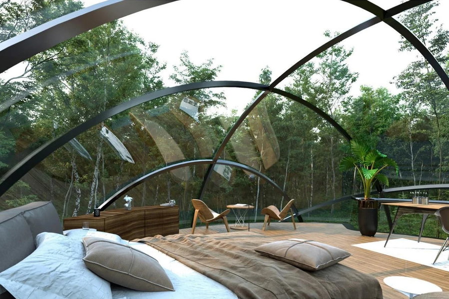 Cozy contemporary bedroom on the upper level of UN10 Design's Living O'Pod dome home.