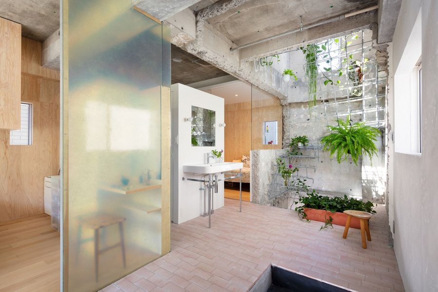 Main atrium inside MAMM Design's concrete-heavy renovation of a Tokyo residence.