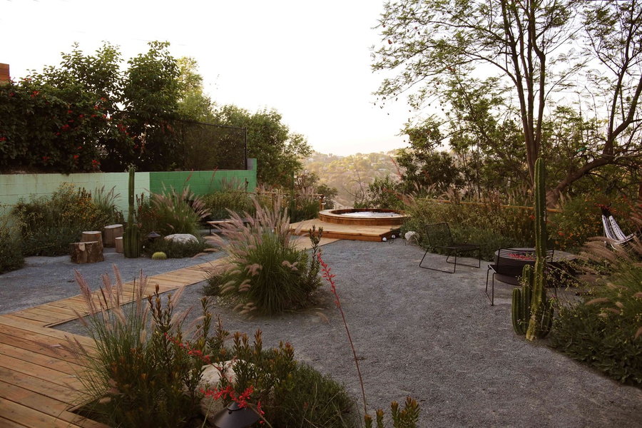 Wooden walkways, desert vegetation, and a sunken cedar tub lend this Sarita Jaccard creation in Los Angeles an almost magical quality.