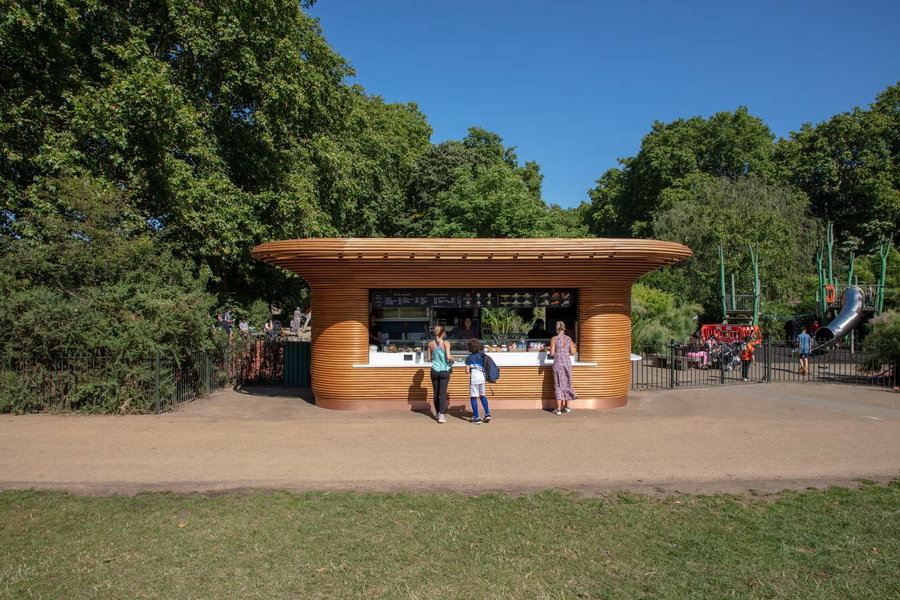 A Mizzi Studio-designed refreshment kiosk near a playground in one of London's Royal Parks.
