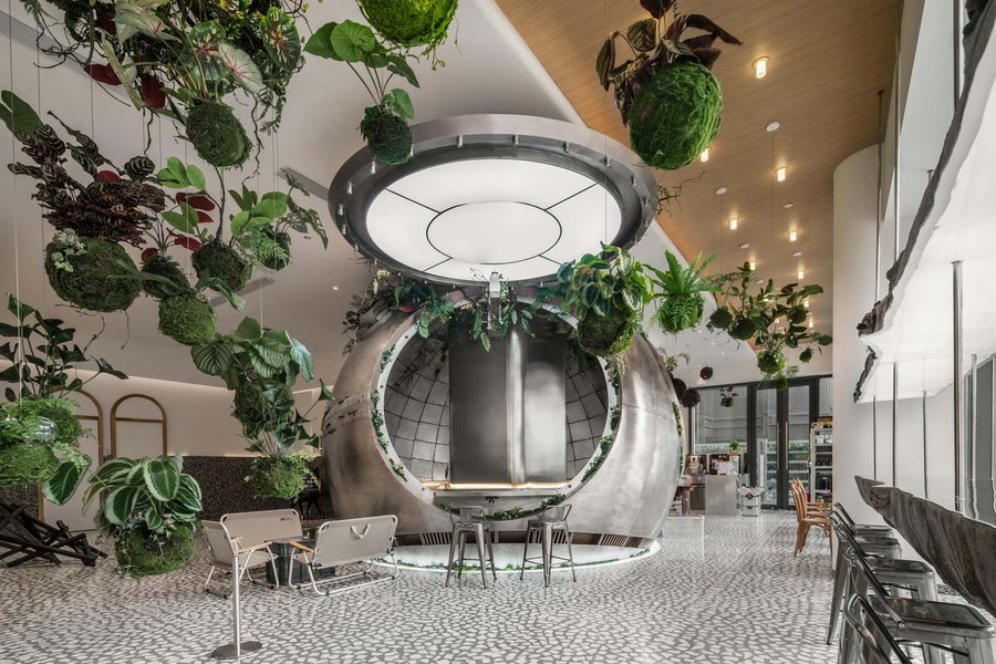 Metallic, greenery-infused interiors of the space-themed Metal Hands Coffee Shop in Shanghai.