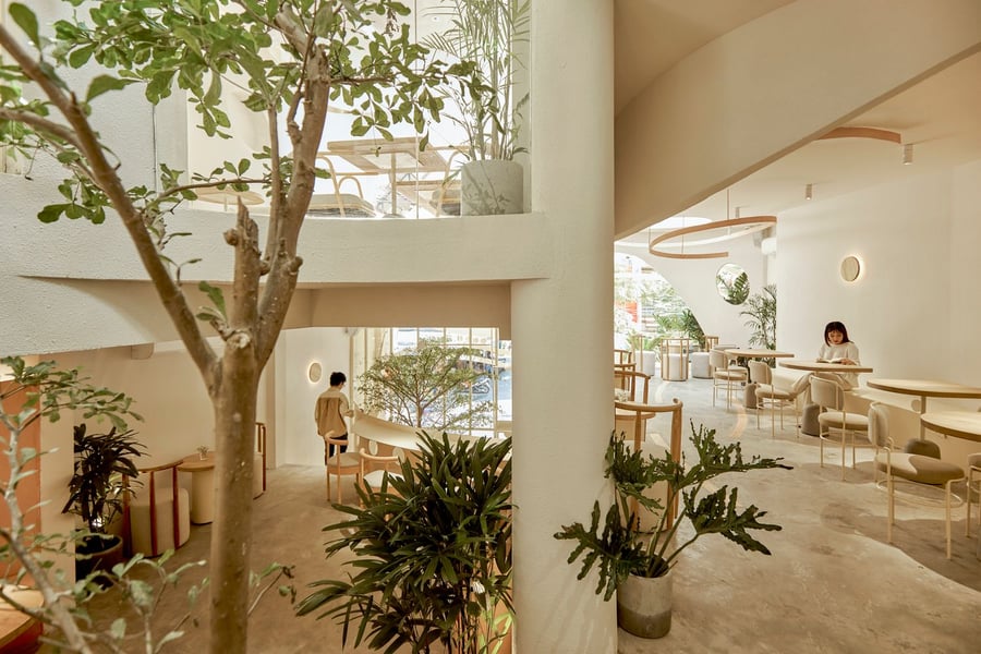 Thanks to an abundance of greenery and open space, every inch of the new nest-like café feels transitional.