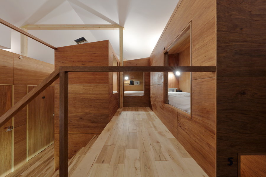 The wooden volumes that make up the Kyoto Suiden-ann Hostel are surrounded by a surprising amount of open walking space.