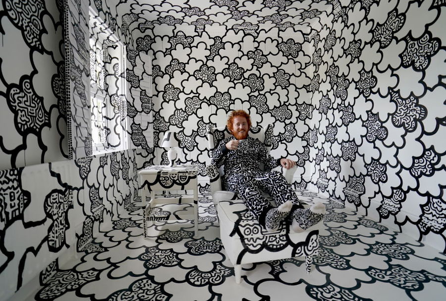 Mr. Doodle sits in a doodle-filled room inside his doodle-covered mansion in Kent, England.
