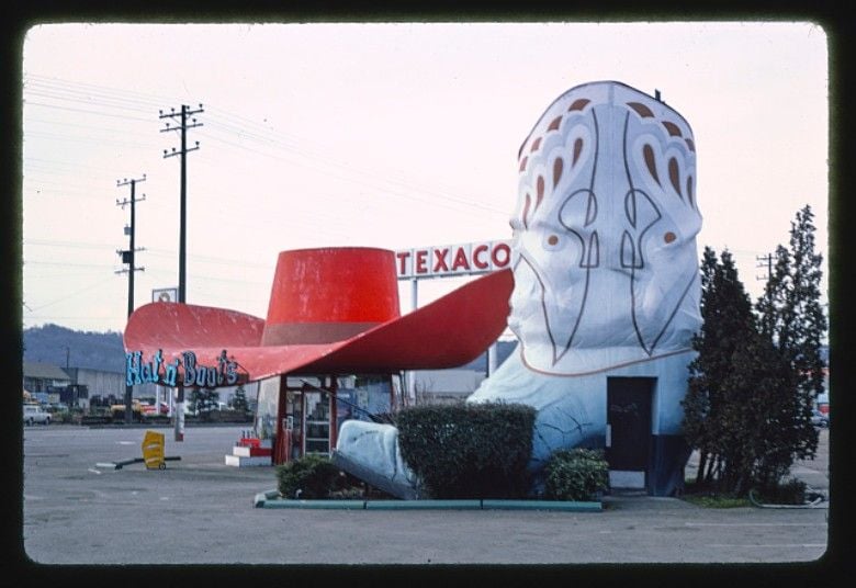 a gas station with a giant hat and boots
