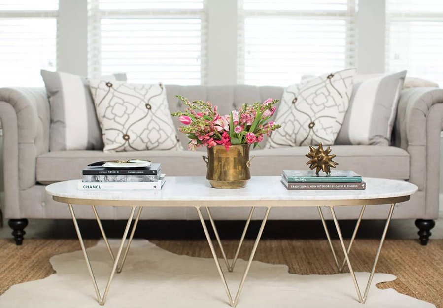 Amanda Carol Interiors used equally-sized stacks of books to bring balance to this elegant coffee table