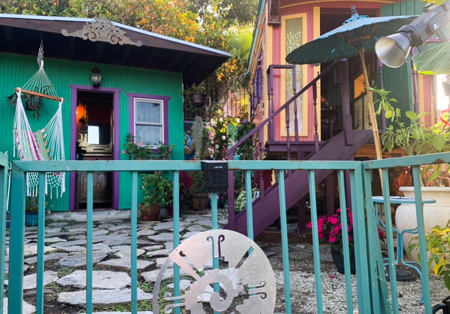 Colorful guest house and fence outside the Vardolandia tiny home wagon. 
