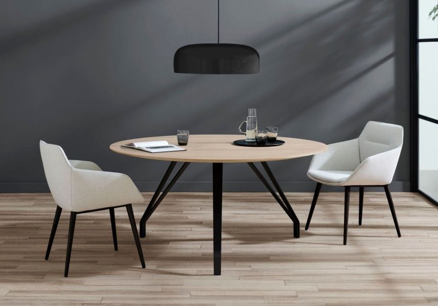 A light-colored wooden table with steel legs, as featured in Davis Furniture's new 