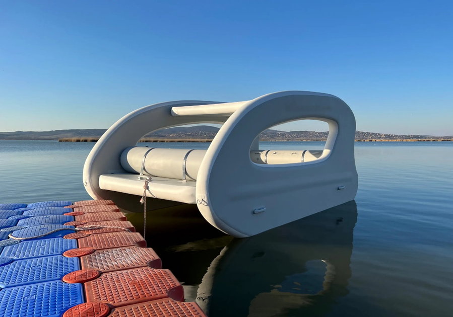 The inflatable Portless Catamaran tethered to a dock.