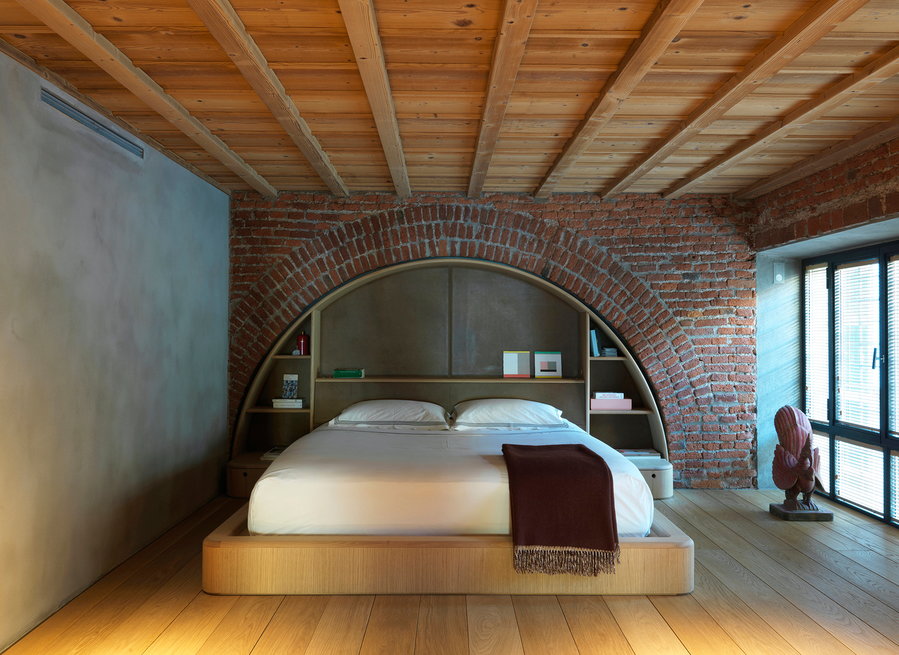 Converted Milan garage bedroom with brick arch