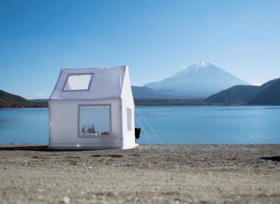 Air Architecture's inflatable tent set up on a beach for the ultimate glamping experience. 