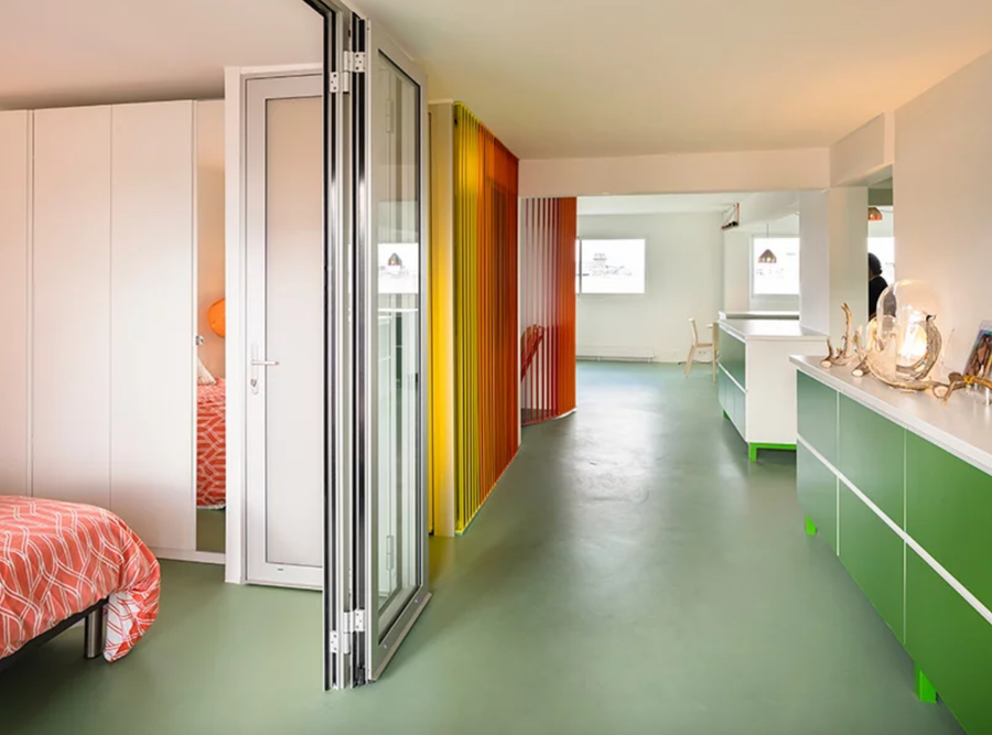 Sliding glass panels close or open the bedroom to the rest of the colorful interiors.