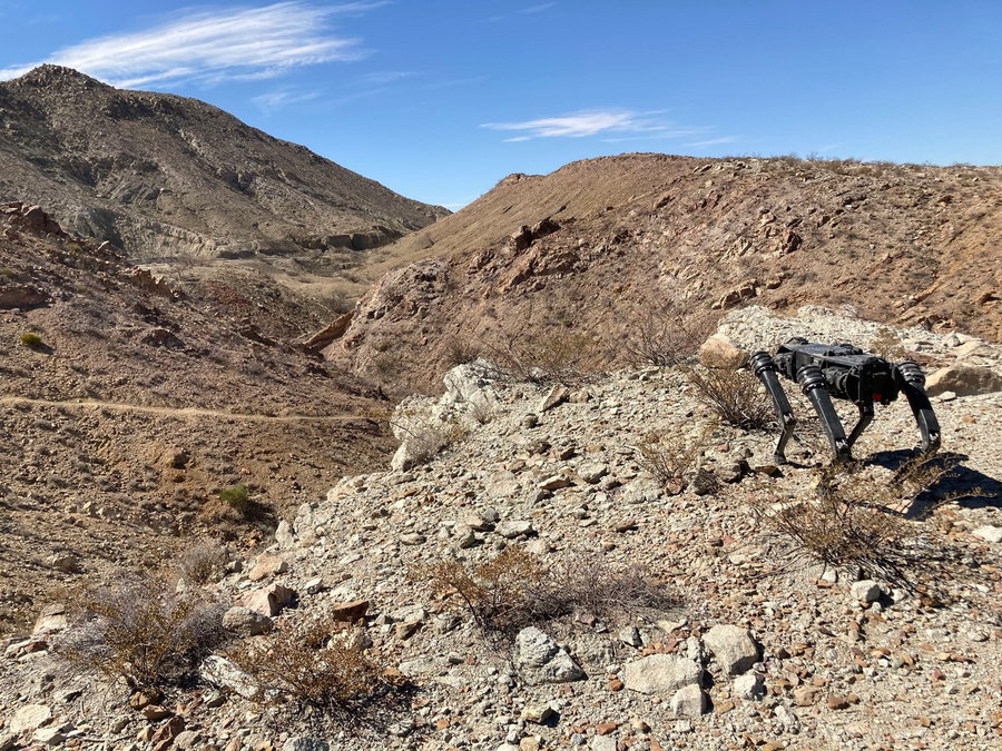 Ghost Robotics robo-dog stands in the rocky terrain along the US-Mexico border.
