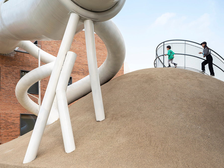 Kids climb around on the sculptural slopes that make up the new Playscape Beijing playground. 