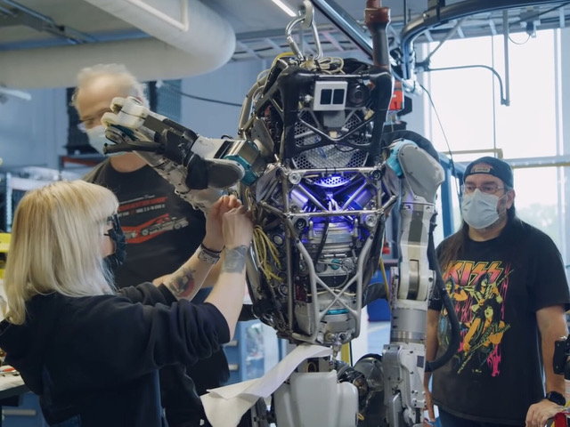 Boston Dynamics engineers work on a humanoid Atlas robot. 