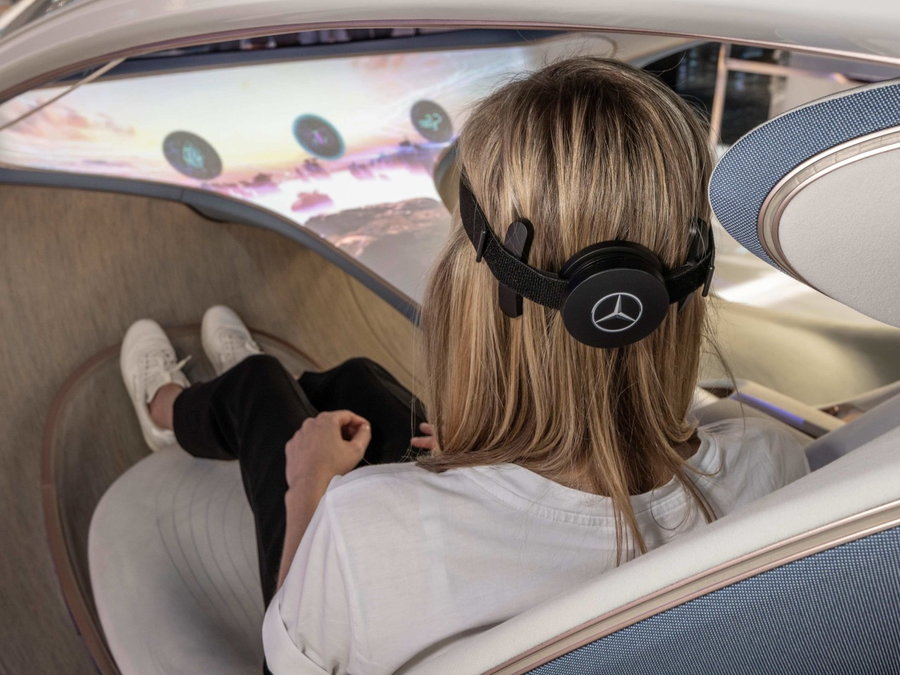 Mercedes-Benz VISION AVTR passenger straps a brain-computer interface to their head to communicate with the car through their brain waves.