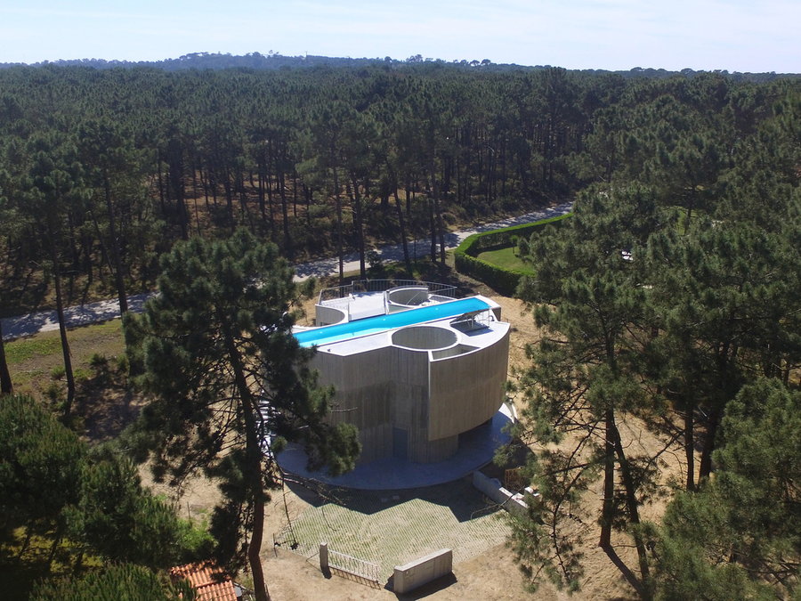 An aerial view of Casa Trevo reveals a gorgeous rooftop pool, as well as voids for skylights and interior courtyards.