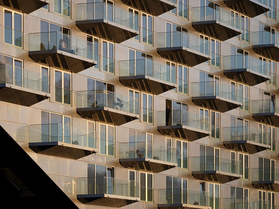 Wall of glass balconies on Amsterdam's ship-like Sluishuis apartment complex.