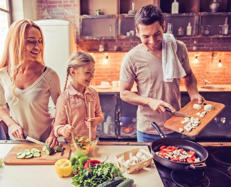 A family enjoys a home-cooked dinner surrounded by clean air and abundant natural light.