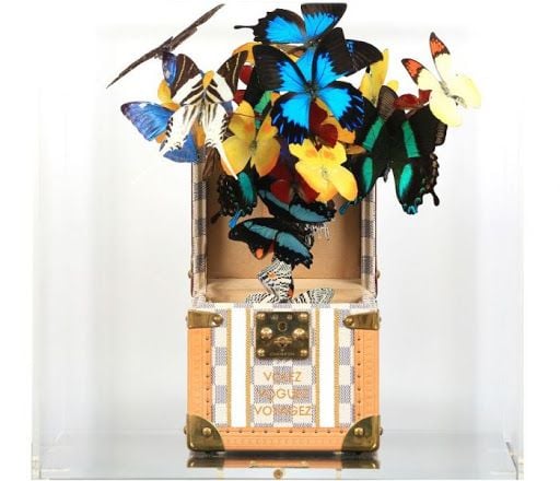 One of several innovative artworks by Roman Feral combining real preserved butterflies with high-end fashion accessories.