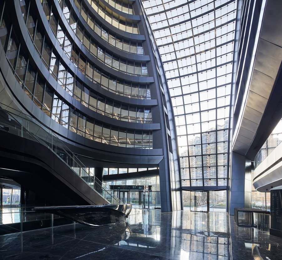 Inside the Leeza SOHO Tower's sleek, tall atrium 