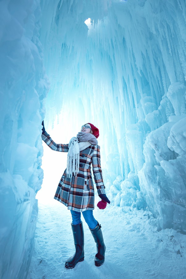 Woman marvels at the crystalline structures inside Brent Christensen's ice castles. 