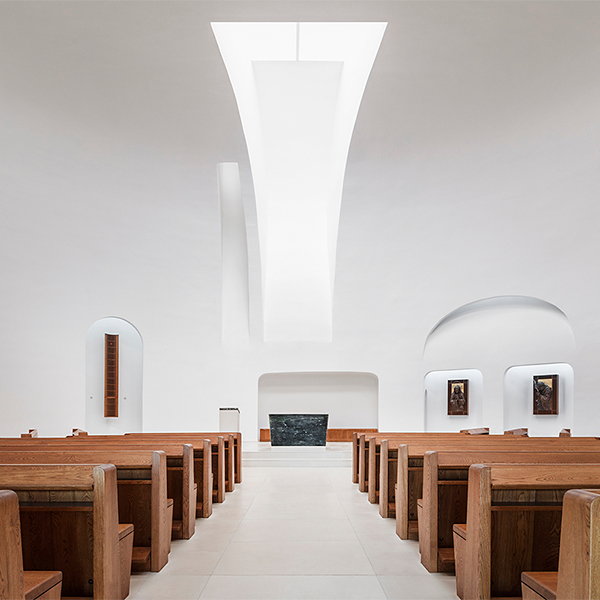 Front-center view of the minimalist chapel area inside Saint Pope John Paul II Church.