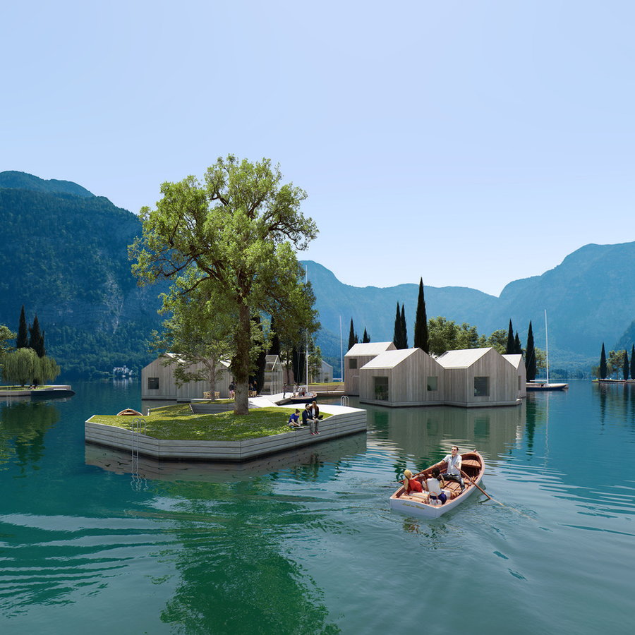 Rendering shows a family on a small boat rowing through a fully-realized Land on Water modular building community.